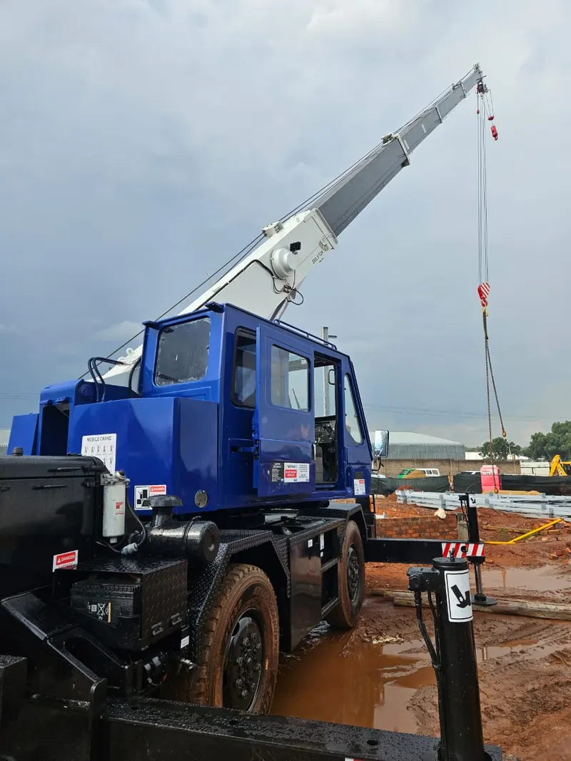 8 ton mobile crane truck with boom extended on site