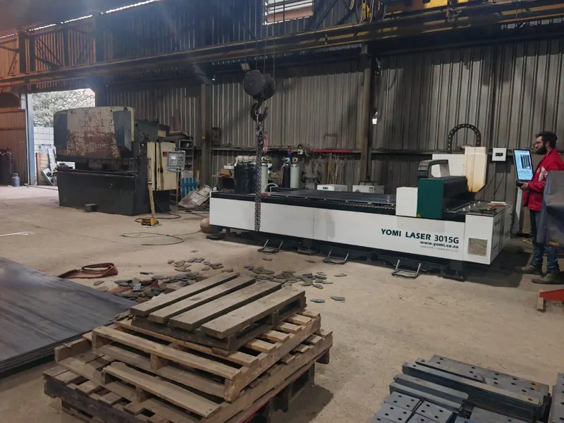 Laser cutting machine in operation in the SteelBand Projects workshop